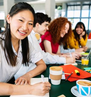 A diverse group of international students participating actively in an English intensive course, enhancing their language skills
